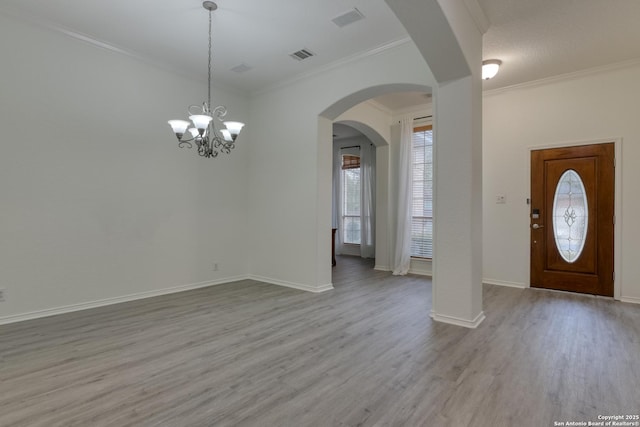 foyer featuring crown molding and light hardwood / wood-style flooring