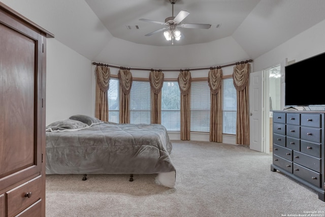 carpeted bedroom with ceiling fan and vaulted ceiling