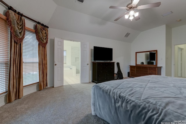 carpeted bedroom featuring ceiling fan, lofted ceiling, and ensuite bathroom