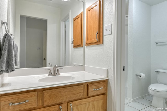 bathroom with vanity, tile patterned floors, and toilet