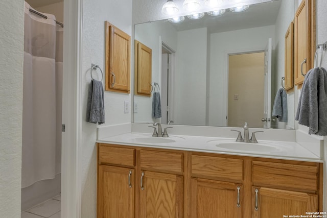 bathroom with tile patterned flooring, vanity, and a shower with curtain