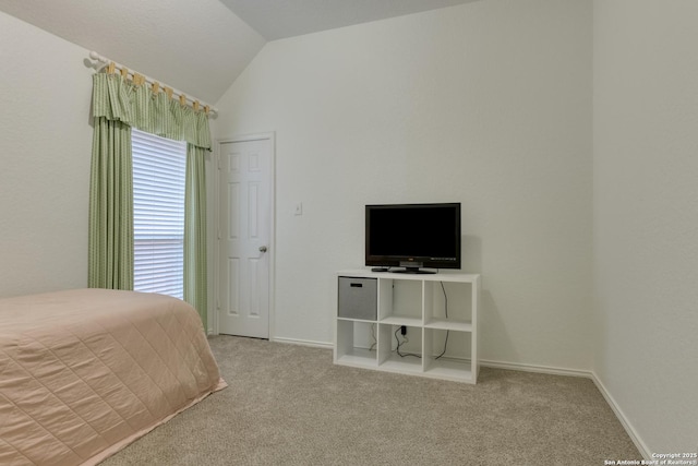 unfurnished bedroom with vaulted ceiling and light carpet