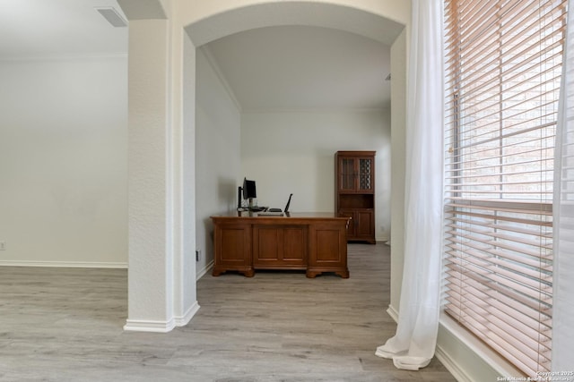 interior space featuring crown molding and light hardwood / wood-style floors