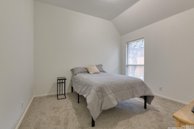 carpeted bedroom featuring lofted ceiling