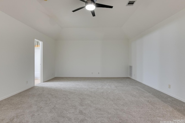 carpeted empty room featuring vaulted ceiling and ceiling fan