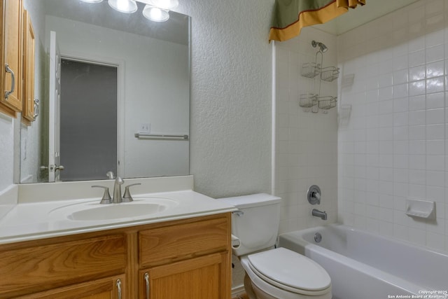 full bathroom featuring vanity, tiled shower / bath combo, and toilet