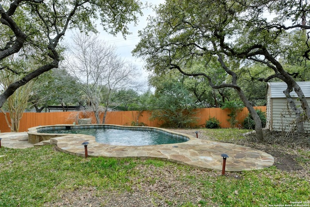 view of swimming pool featuring pool water feature and a patio area