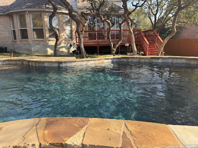 view of swimming pool with a deck