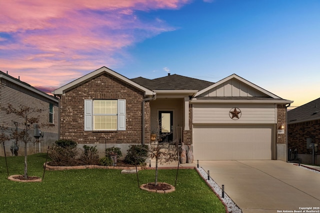 ranch-style house featuring a garage and a lawn