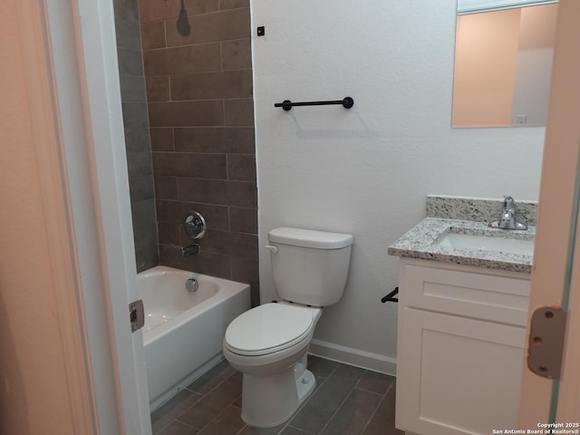 full bathroom featuring vanity, tiled shower / bath, and toilet