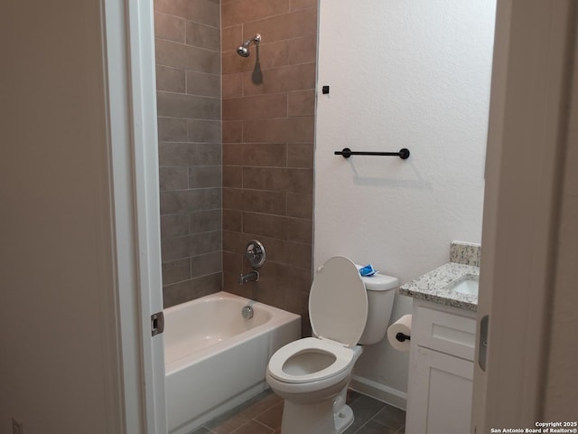 full bathroom featuring tile patterned floors, vanity, toilet, and tiled shower / bath combo