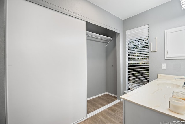 washroom with sink and light wood-type flooring