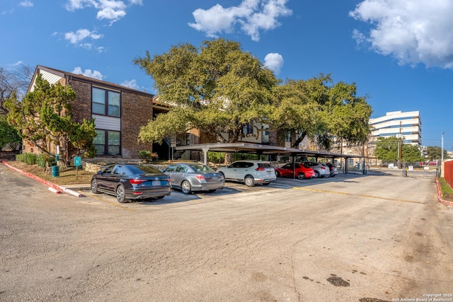 view of parking / parking lot featuring a carport