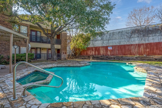 view of pool with an in ground hot tub