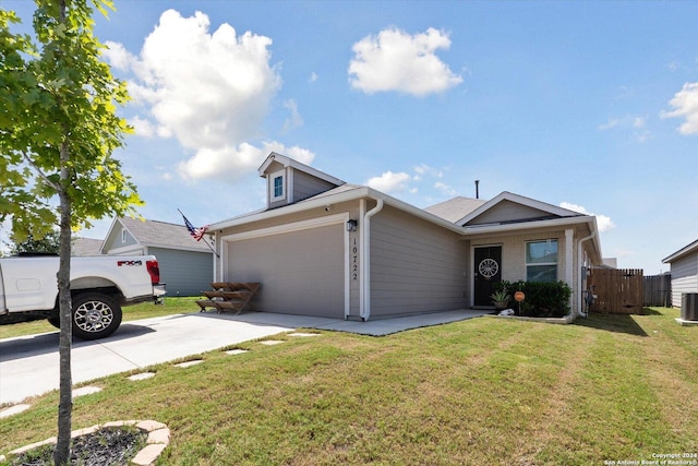 ranch-style home with a garage, central AC, and a front lawn