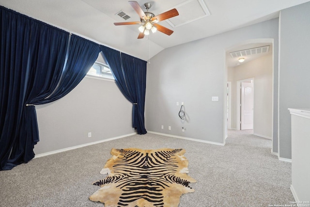 carpeted empty room with vaulted ceiling and ceiling fan