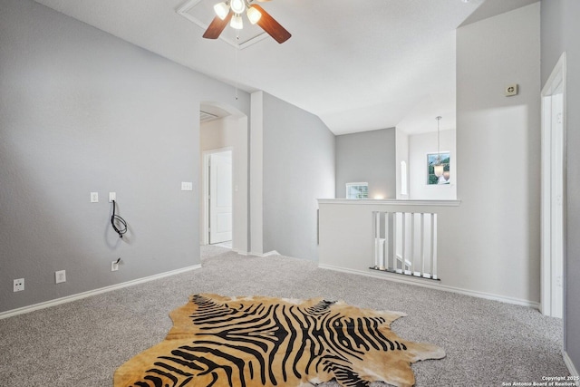 carpeted empty room featuring vaulted ceiling and ceiling fan