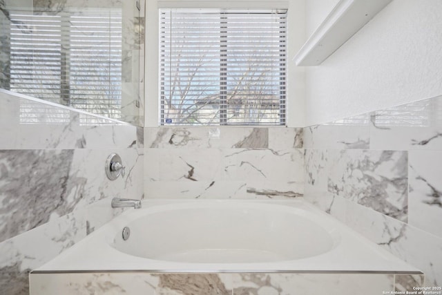 bathroom featuring tiled tub