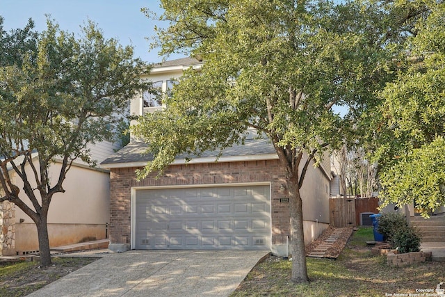 view of property hidden behind natural elements with cooling unit