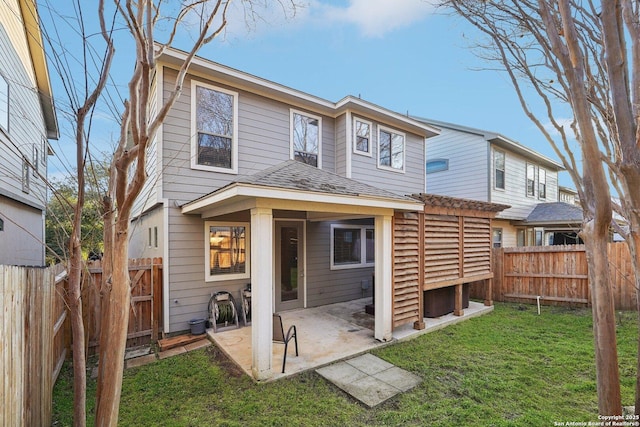 rear view of property with a yard and a patio