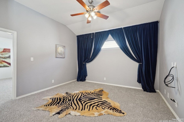 bedroom with ceiling fan, vaulted ceiling, and carpet