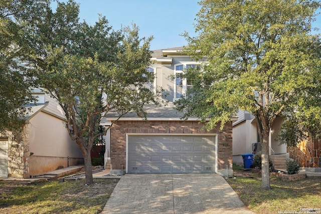 view of property hidden behind natural elements with a garage