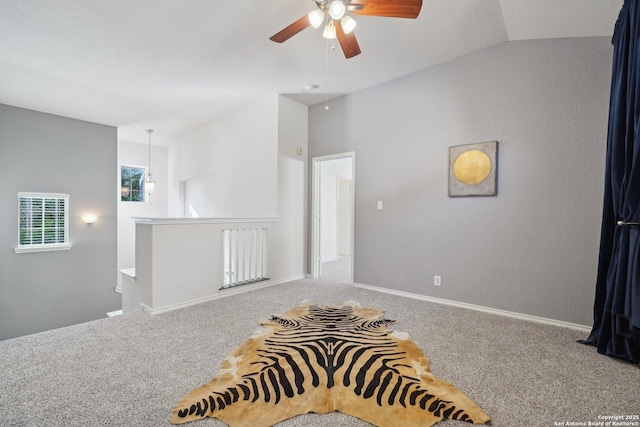 empty room featuring carpet floors and vaulted ceiling