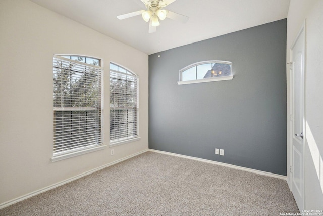 carpeted empty room featuring ceiling fan