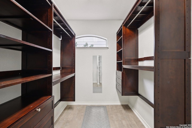 walk in closet featuring light hardwood / wood-style flooring