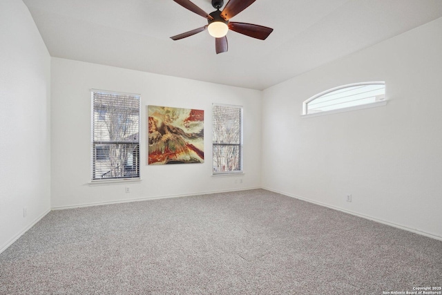 carpeted spare room featuring ceiling fan