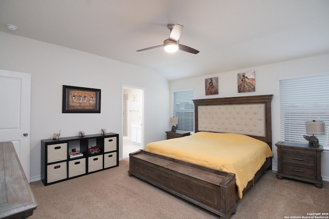 bedroom featuring lofted ceiling, light colored carpet, ceiling fan, and ensuite bathroom