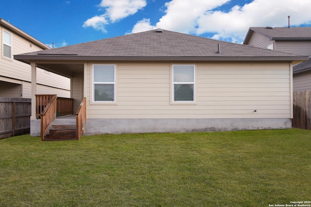 back of house with a lawn