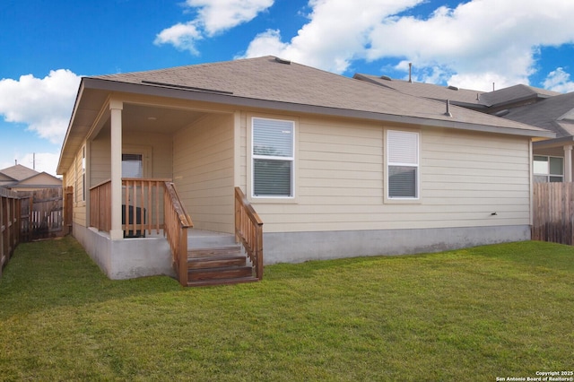 rear view of house with a yard