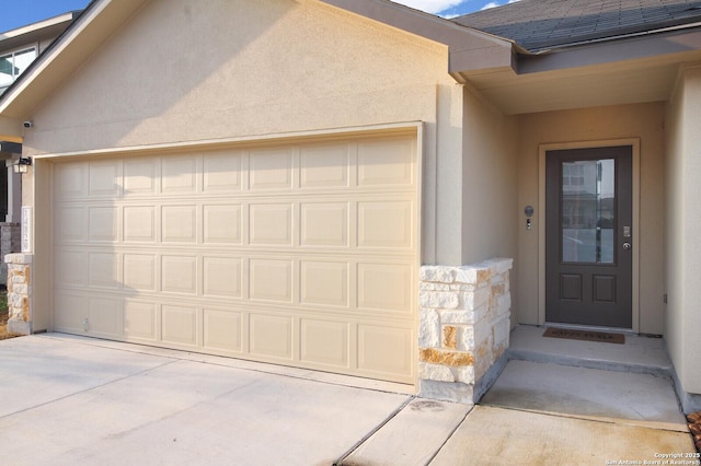 view of exterior entry featuring a garage