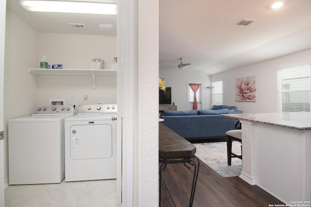 washroom featuring hardwood / wood-style flooring, ceiling fan, and washer and dryer