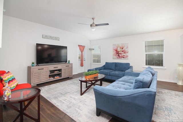 living room featuring dark wood-type flooring and ceiling fan