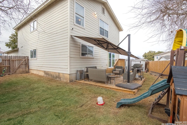 rear view of house with an outdoor hangout area, a playground, and a lawn