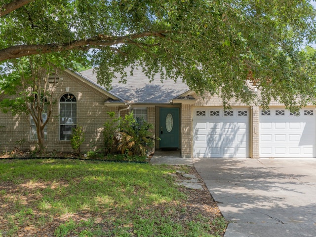 view of front of home featuring a garage and a front lawn