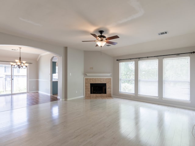 unfurnished living room featuring a wealth of natural light, a fireplace, and light hardwood / wood-style flooring