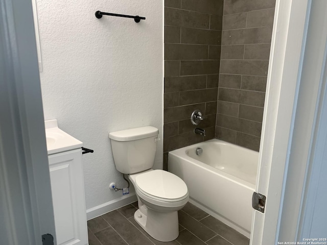 full bathroom featuring vanity, toilet, and tiled shower / bath combo