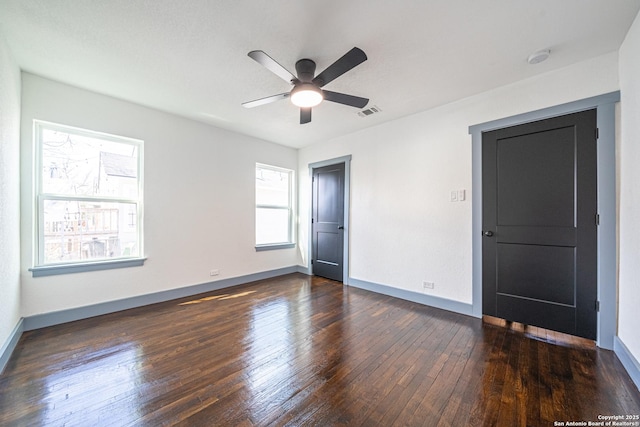 unfurnished bedroom with ceiling fan and dark hardwood / wood-style floors