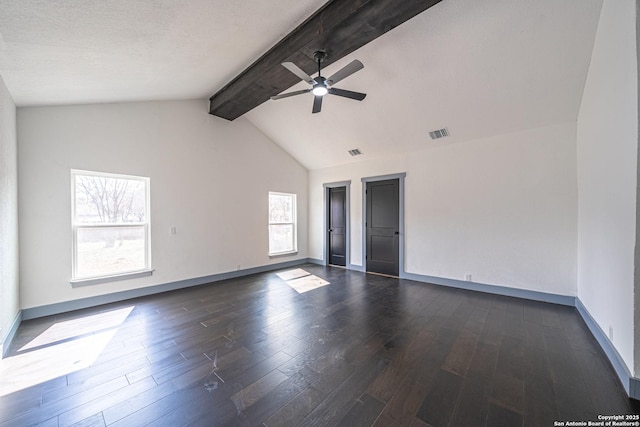 empty room featuring dark wood-type flooring, ceiling fan, and vaulted ceiling with beams