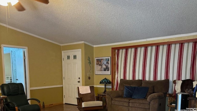 living room with crown molding, vaulted ceiling, ceiling fan, and a textured ceiling