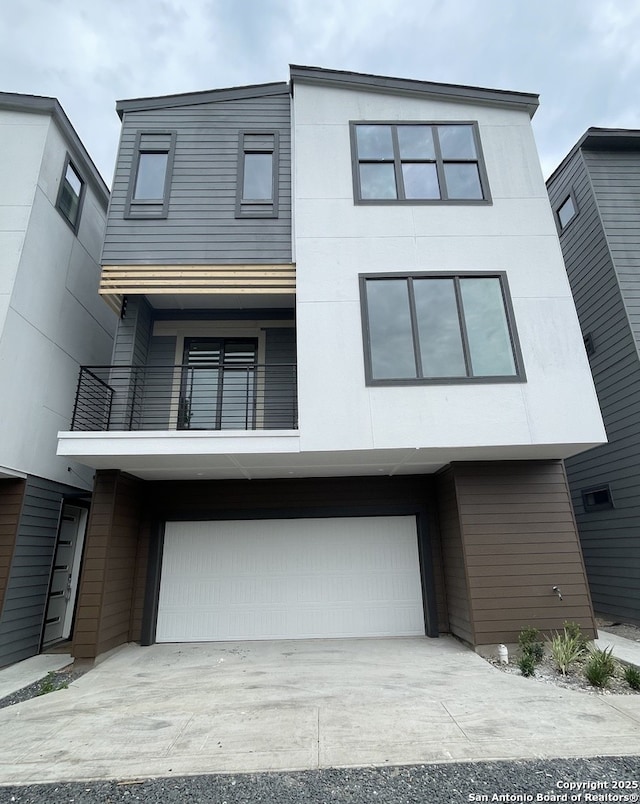 contemporary house featuring a balcony and a garage