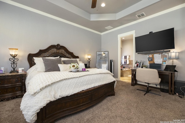 carpeted bedroom with crown molding, a raised ceiling, ceiling fan, and ensuite bathroom