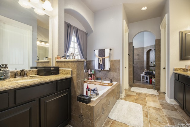 bathroom featuring vanity and plus walk in shower