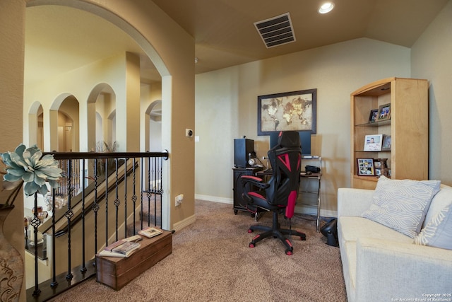 home office with lofted ceiling and carpet