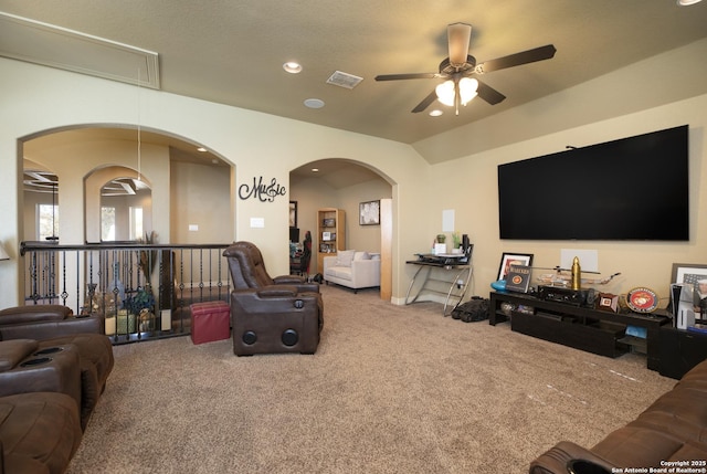 carpeted living room featuring vaulted ceiling and ceiling fan