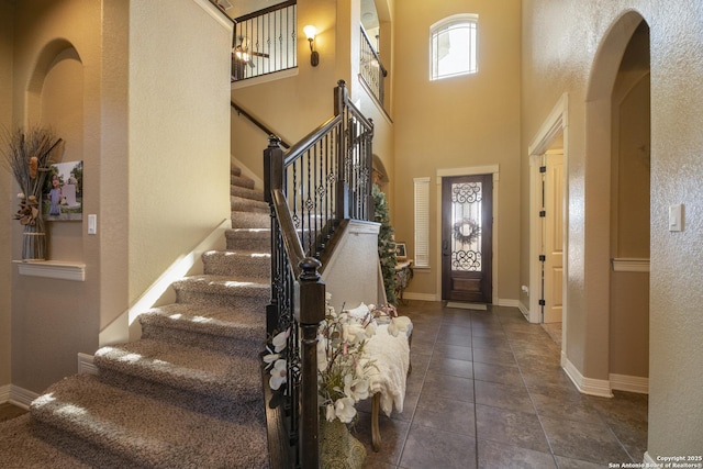 tiled entrance foyer featuring a high ceiling