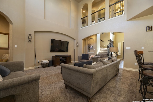 carpeted living room featuring a high ceiling